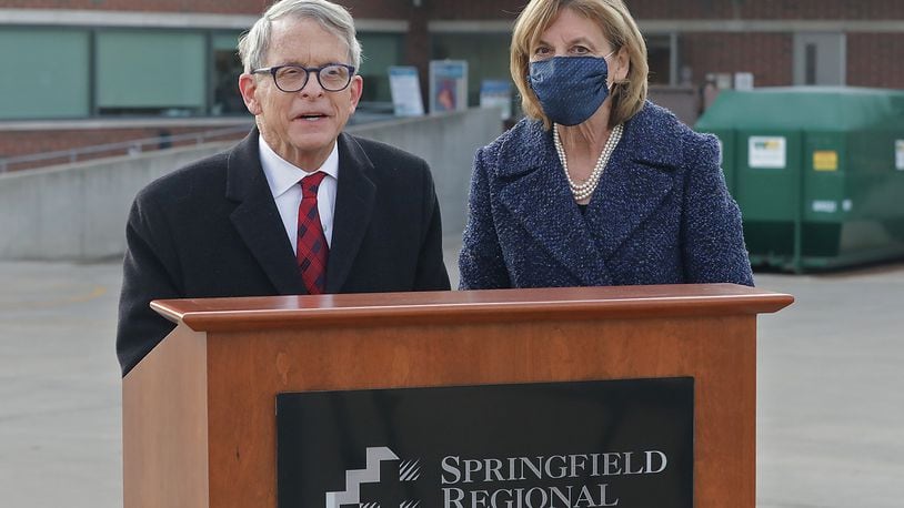 Gov. Mike DeWine with  his wife, Fran, talk to members of the media after the first shipment of COVID-19 vaccine arrived at Springfield Regional Medical Center Tuesday morning. BILL LACKEY/STAFF