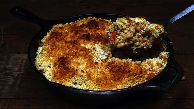 White beans stew with carrots and lots of garlic to make a satisfying dinner underneath a blanket of crisp breadcrumbs. (Terrence Antonio James/Chicago Tribune/TNS)