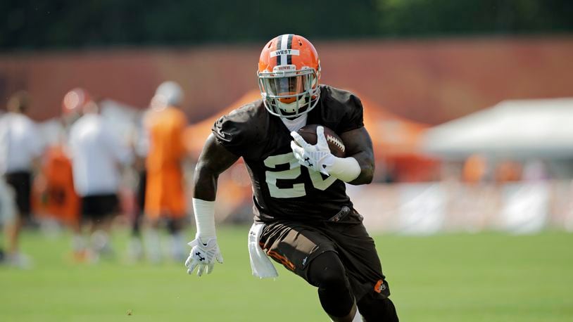 Cleveland Browns running back Terrance West runs the ball at the NFL football team's training camp in Berea, Ohio Saturday, July 26, 2014. (AP Photo/Mark Duncan)