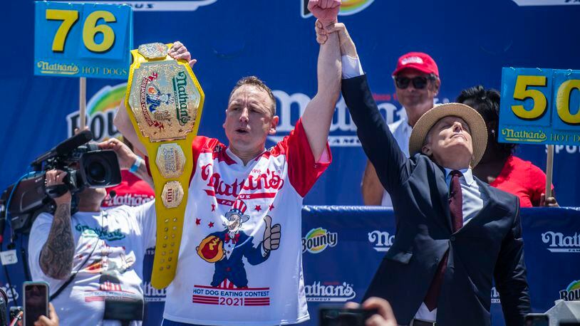 Chowdown champ Joey “Jaws” Chestnut celebrates after winning the the Nathan's Famous Fourth of July International Hot Dog-Eating Contest in Coney Island's Maimonides Park on Sunday, July 4, 2021, in the Brooklyn borough of New York. (AP Photo/Brittainy Newman)