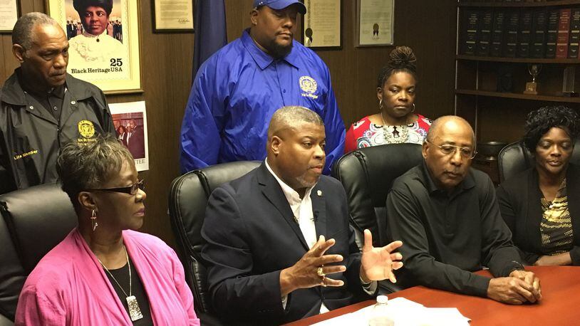 Derrick L. Foward, NAACP Dayton Unit president (center), and education chair Lauretta Williams (left) said Dunbar High School coaches and athletic directors should be punished by the OHSAA, not all athletic teams from all DPS schools. MARC PENDLETON / STAFF