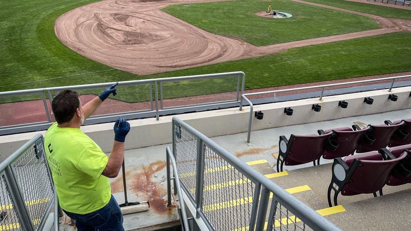 Kenny York paints the walkway in the stands at Day Air Ballpark Wednesday May 5, 2021. JIM NOELKER/STAFF