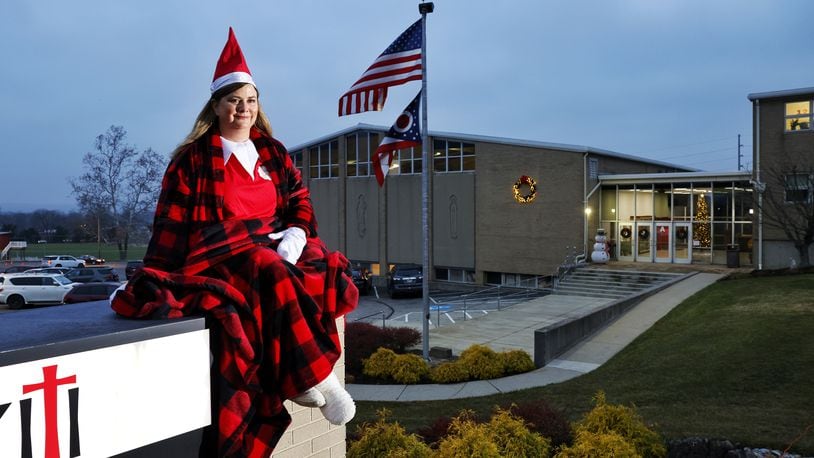 Dawn Pickerill, Principal of St. John XXIII Catholic School in Middletown, has been posing as "Elf on the Shelf" in different areas around the school in the mornings as students arrive. NICK GRAHAM/STAFF