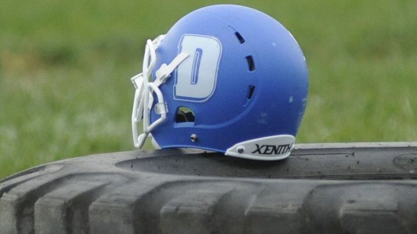 A Dunbar High School football helmet rests on a workout tire. MARC PENDLETON / STAFF