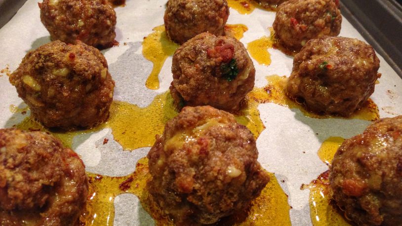 Be sure to use parchment paper in the pan when you bake these Smokn’ Bacon Balls; otherwise, they’ll drip all over the place because they’re loaded with bacon lardons, ground chuck, heavy cream and smoked cheddar. (CONNIE POST/STAFF PHOTO)