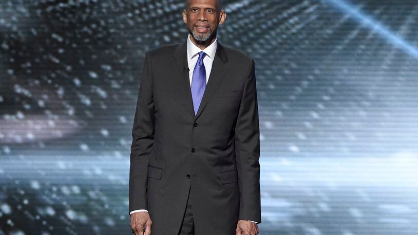 FILE - In this July 13, 2016, file photo, Kareem Abdul-Jabbar presents a tribute to Muhammad Ali at the ESPY Awards at the Microsoft Theater in Los Angeles. Abdul-Jabbar's next book will be a fond look back at his long friendship with John Wooden, the celebrated basketball coach at UCLA. "Coach Wooden and Me" will be published next June and will combine personal memories and lessons learned from his friend and mentor, Grand Central Publishing told The Associated Press on Wednesday, Sept. 28. (Photo by Chris Pizzello/Invision/AP, File)