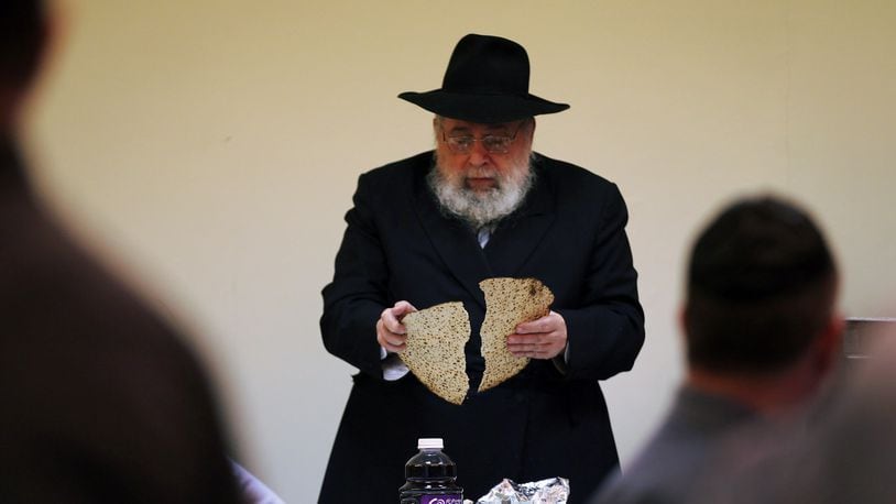 MIAMI BEACH, FL - MARCH 25: Rabbi Efraim Katz breaks a piece of matzo as he leads a community Passover Seder at Beth Israel synagogue on March 25, 2013 in Miami Beach, Florida. The community Passover Seder that served around 150 people has been held for the past 30 years and is welcome to anyone in the community that wants to commemorate the emancipation of the Israelites from slavery in ancient Egypt. (Photo by Joe Raedle/Getty Images)