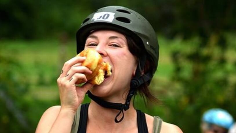 A participant in a previous Tour De Donut gets into the spirit of the event by downing a donut. CONTRIBUTED