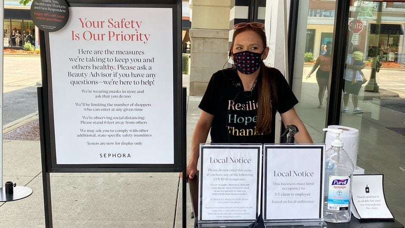 Sephora employee running a sanitization station for customers as they come in and leave the store. Cosette Gunter/ Staff Photo