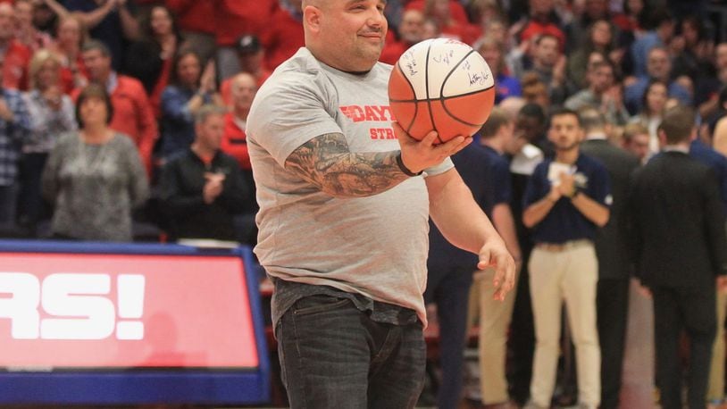 Jeremy Ganger is honored during a game between Dayton and George Washington on Saturday, March 7, 2020, at UD Arena. David Jablonski/Staff