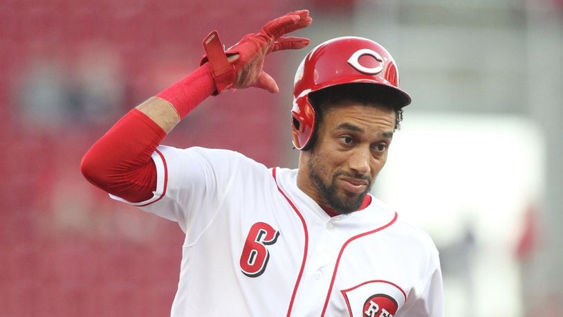 The Reds’ Billy Hamilton tries to hold onto his helmet as he runs to third base against the Cardinals on Thursday, April 12, 2018, at Great American Ball Park in Cincinnati. David Jablonski/Staff