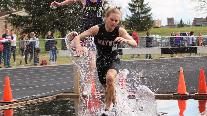 Wayne High School senior Lucas Houk, competing at the steeplechase at the recent Herb Hartman Invitational in Troy, is closing in on the Warriors’ outdoor records in the 800, 1,600 and 3,200. He holds the indoor marks in those events, plus the steeplechase and is the Warriors’ cross country record holder. Greg Billing / Contributed