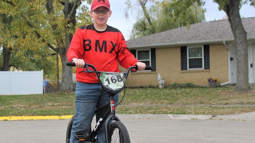 Nicholas Lamb rides his BMX bike in his Huber Heights neighborhood. Lamb wants a skate park to be built in Huber so that he and other kids can safely do the sport. STAFF/BONNIE MEIBERS