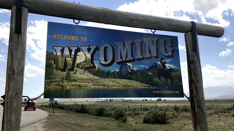 FILE - A sign on the border of Wyoming and Montana appears on the side of Belfry Highway, May 24, 2017, in Powell, Wyo. Republicans in Wyoming will decide Saturday which presidential candidate will get their state's votes at the GOP national convention but there's only one choice.(AP Photo/Robert Yoon, File)