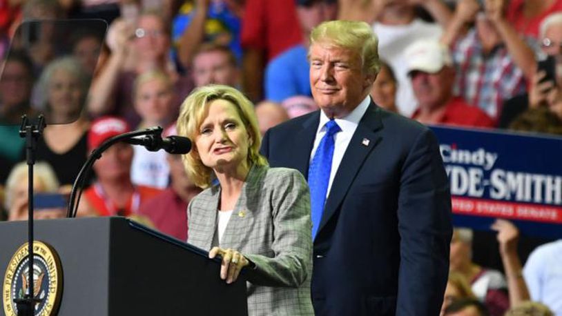 Mississippi Sen. Cindy Hyde-Smith (L) stands on stage with President Donald Trump at a “Make America Great Again” rally at Landers Center in Southaven, Mississippi, on October 2, 2018.