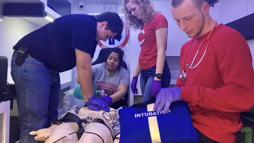 Students in Sinclair’s EMT certificate program practice in an ambulance simulator in the college’s new health sciences center.