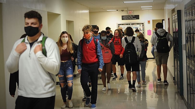 Beavercreek High School students walk to their next classes during an October school day. BHS students are learning remotely this week, then hope to stair-step their way back -- hybrid the week of Jan. 11, and fully in-person the week of Jan. 19.