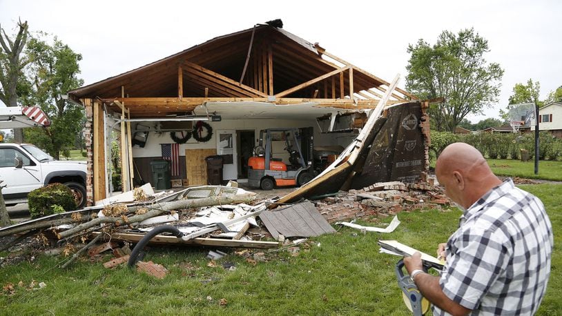 Contractor Bob Westfall begins the estimate process for this home damaged by a tornado on Coppersmith Avenue in Butler Twp. during the severe weather outbreak on Memorial Day. TY GREENLEES / STAFF