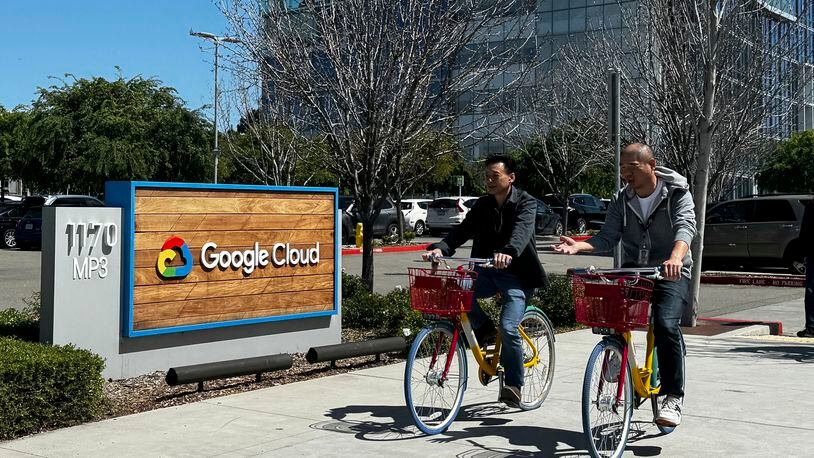 Two people ride past the Google sign outside the Google offices in Sunnyvale, Calif., on Thursday, April 18, 2024. Google has fired 28 employees who were involved in protests over the tech company’s cloud computing contract with the Israeli government. The workers held sit-ins at the company’s offices in California and New York over Google’s $1.2 billion contract to provide custom tools for Israeli’s military. (AP Photo/Terry Chea)