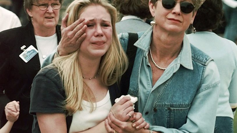 FILE - Fran Allison, right, comforts her daughter, Brooke, after they were reunited following a shooting at Columbine High School in Littleton, Colo., April 20, 1999. Twenty-five years later, The Associated Press is republishing this story about the attack, the product of reporting from more than a dozen AP journalists who conducted interviews in the hours after it happened. The article first appeared on April 22, 1999. (AP Photo/Ed Andrieski, File)