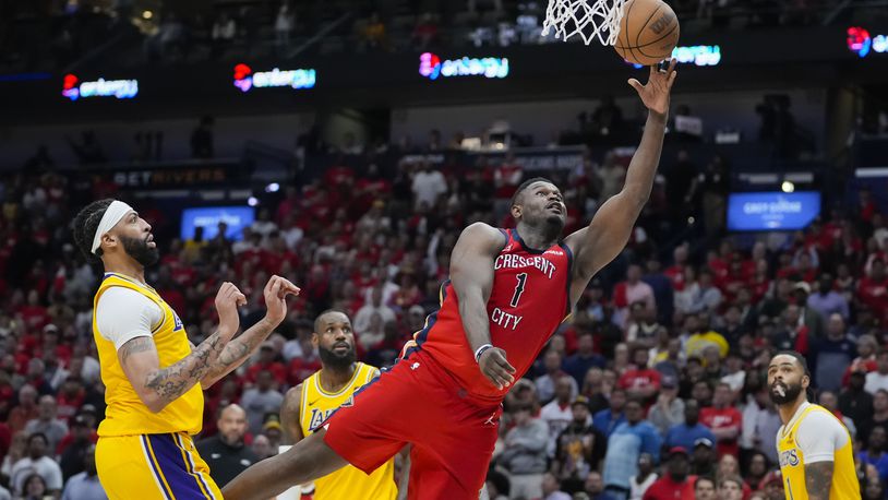 New Orleans Pelicans forward Zion Williamson (1) goes to the basket ahead of Los Angeles Lakers forward Anthony Davis in the second half of an NBA basketball play-in tournament game Tuesday, April 16, 2024, in New Orleans. The Lakers won 110-106. (AP Photo/Gerald Herbert)