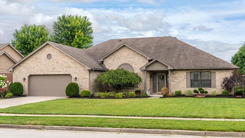 The brick ranch has about 3,040 sq. ft. of living space. Manicured landscaping surrounds the 3-bedroom house, which includes a 2-car garage and a rear concrete patio. CONTRIBUTED PHOTO/DAYTON HOME PHOTOGRAPHY