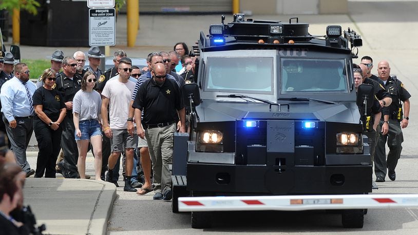 Members of the Clark County Sheriff's Office and members of other law enforcement agencies follow a SWAT vehicle carrying the body of fallen deputy Matthew Yates from the Montgomery County Corner's Office Monday July 25, 2022. The processional left Dayton to return Yates' body to Clark County. MARSHALL GORBY\STAFF