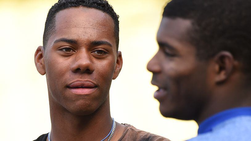 Hunter Greene, from Stevenson Ranch, Calif., is expected to make his professional debut tonight with the Reds' Pioneer League rookie team, batting sixth as the designated hitter. 
Cincinnati made him the No. 2 overall pick in the June draft. Here, he's seen talking to Dodgers' outfielder Yasiel Puig before a game against the Phillies on April 28 in Dodger Stadium.