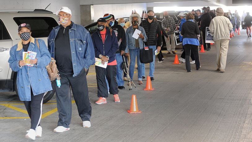 Long lines for early voting at the Montgomery County Board of Elections stretched out into the parking garage Tuesday. MARSHALL GORBY\STAFF