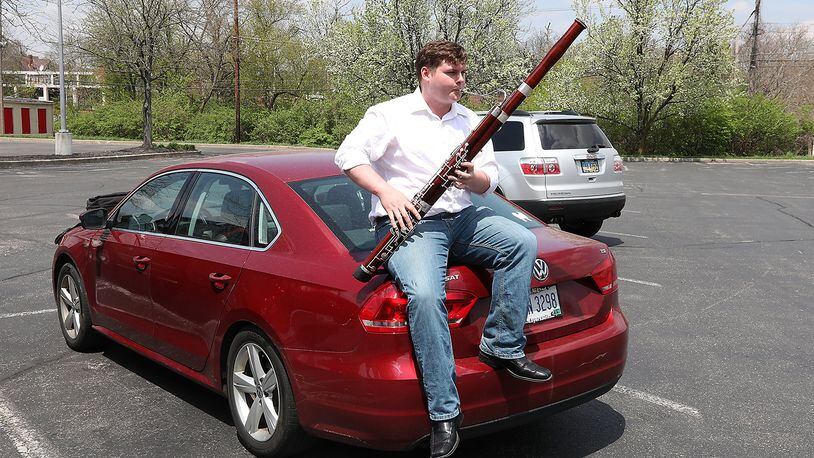 Eric Barga practices his bassoon while sitting on the trunk of his car in the Covenant Presbyterian Church parking lot Wednesday, May 2, 2018 just like he was recently when the Springfield Police Division received a 911 call reporting that he had a gun. Bill Lackey/Staff