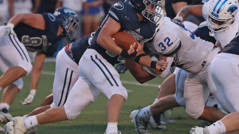 Fairmont's Drew Baker carries the ball against Springboro during Friiday's game. BILL LACKEY/STAFF