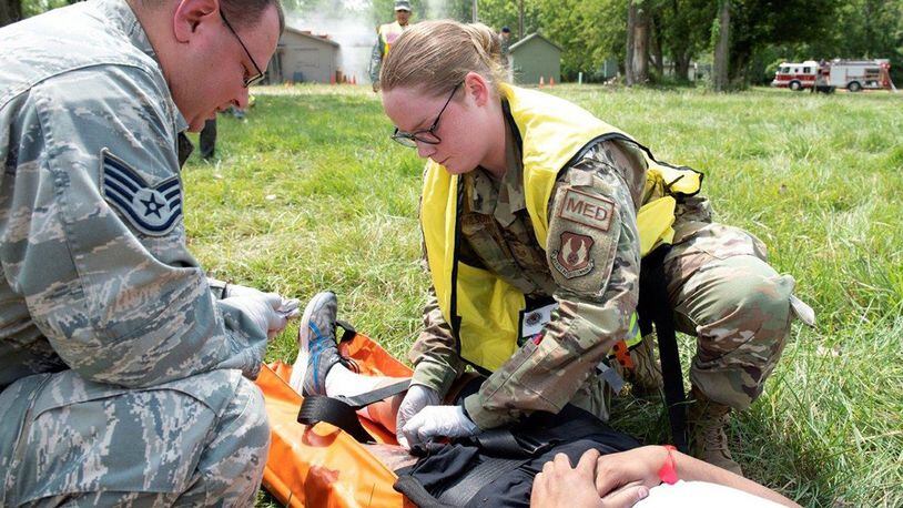 Medics Staff Sgt. Richard Berhiet and Staff Sgt. Emily Wilson, both with the 88th Medical Group, attend to the simulated wound of a volunteer victim involved in a gas leak explosion training scenario during a base mass casualty exercise at the Warfighter Training Center, Wright-Patterson Air Force Base, Aug. 1. (U.S. Air Force photo/Michelle Gigante)