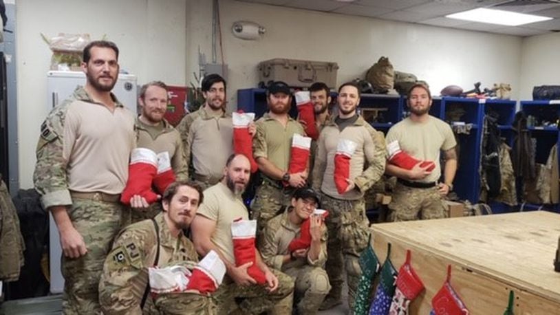 The Blue Star Mothers organization sends goodies to troops all over the world throughout the year. Pictured are Army troops in Afghanistan receiving holiday stockings. CONTRIBUTED
