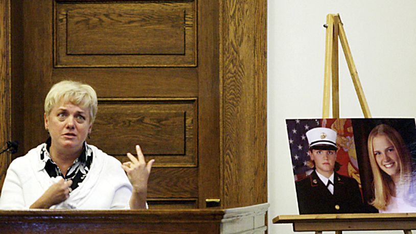 Mary Lauterbach testifies as images of her daughter, Marine Lance Cpl. Maria Lauterbach, sit next to the stand during the murder trial of Cesar Laurean in the Wayne County Superior Courthouse in Goldsboro, N.C. Associated Press photo by Troy Herring