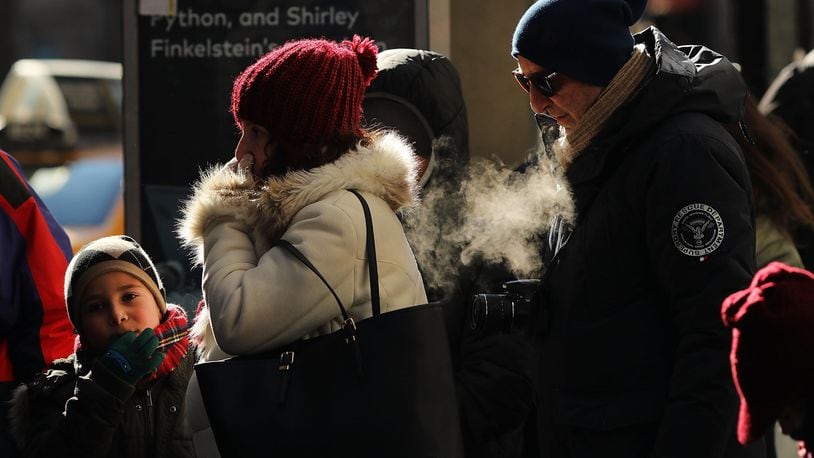 People walk through a frigid Manhattan on December 28, 2017 in New York City. Dangerously low temperatures and wind chills the central and eastern United States are making outdoor activity difficult for many Americans.  Little relief from the below normal temperatures is expected the first week of the New Year.   (Photo by Spencer Platt/Getty Images)