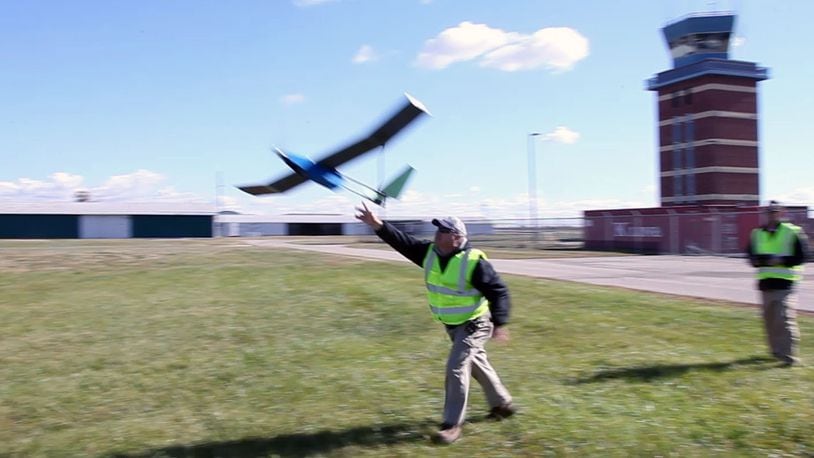 SelectTech Geospatial’s Executive Director Frank Beafore, left, launches a UAS as chief pilot Jade Lowrey flies at the company’s Springfield location in October 2015. TY GREENLEES / STAFF