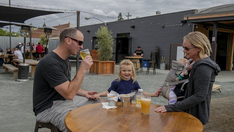 Michael and Heather Wadekamper and children Tracie Zelaney enjoy Friday afternoon at SacYard Tap House on May 25, 2018. The tap house allows children in the outdoor patio and front area. (Jose Luis Villegas/Sacramento Bee/TNS)
