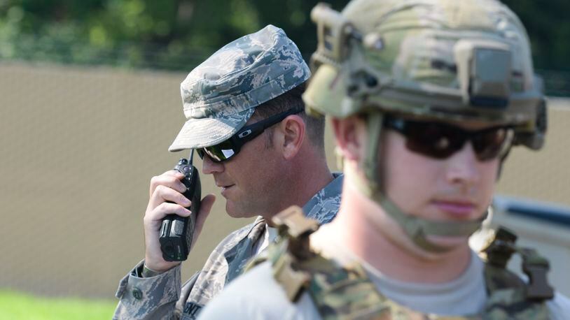 Staff Sgt. Michael Kent, 788th Civil Engineer Squadron, explosive ordinance disposal technician, radios back to the EOD control desk information from Senior Airman Tyler Squibb, 788th CES, EOD technician, after he performed a recon on an unexploded ordinance during an exercise at Wright-Patterson Air Force Base in August 2016. (U.S. Air Force photo / Wesley Farnsworth)