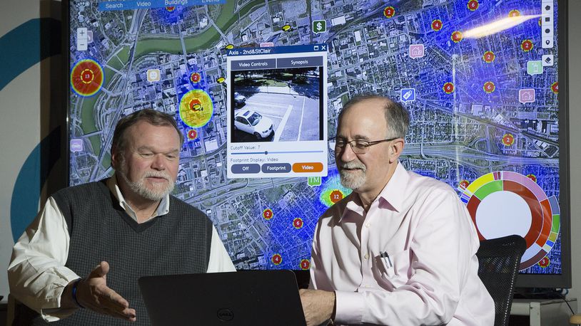 In this 2016 file photo, Larrell Walters, then-Universal Technology Corp’s senior director of commercial products, left, and company CEO Joe Sciabica are reviewing a law enforcement data mapping system called Footprint. TY GREENLEES / STAFF