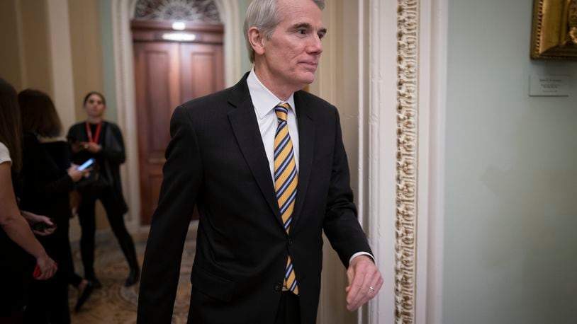 FILE - In this Jan. 31, 2020, file photo Sen. Rob Portman, R-Ohio, arrives as the impeachment trial of President Donald Trump on charges of abuse of power and obstruction of Congress resumes in Washington. Pressure is increasing on a Trump administration official to authorize a formal transition process for President-elect Joe Biden. Portman of Ohio on Monday, Nov. 23, called for the head of the General Services Administration to release money and staffing needed for the transition. (AP Photo/J. Scott Applewhite, File)