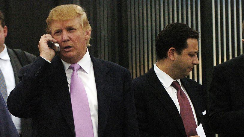 In this Sept. 14, 2005, file photo, businessman Donald Trump, left, talks on his cellphone with Felix Sater, right, outside after speaking at the Bixpo 2005 business convention at the Budweiser Events Center in Loveland, Colorado.