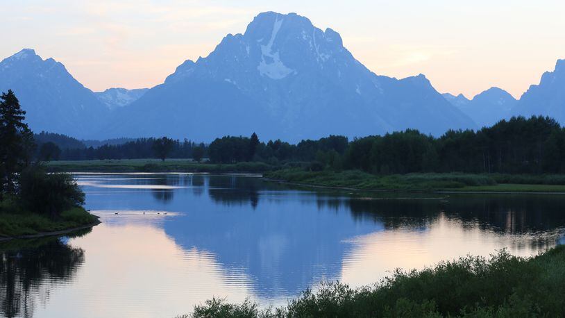 The rising sun illuminates the front of the Teton Mountains, while, as here, the setting sun back lights the peaks that rise abruptly from a valley floor, making them unique among North American mountain ranges. (Dennis Anderson/Minneapolis Star Tribune/TNS)