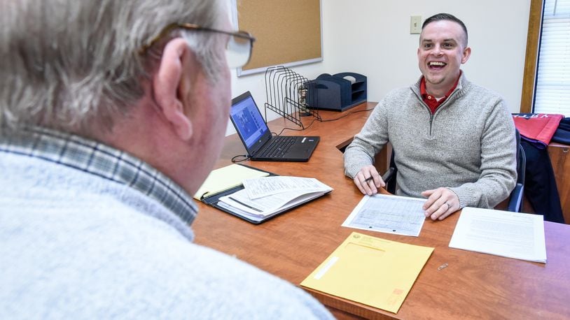 Casey James, right, service officer with the Butler County Veterans Service Commission, meets with a client in the new Middletown branch office on Breiel Boulevard earlier this year. NICK GRAHAM/STAFF