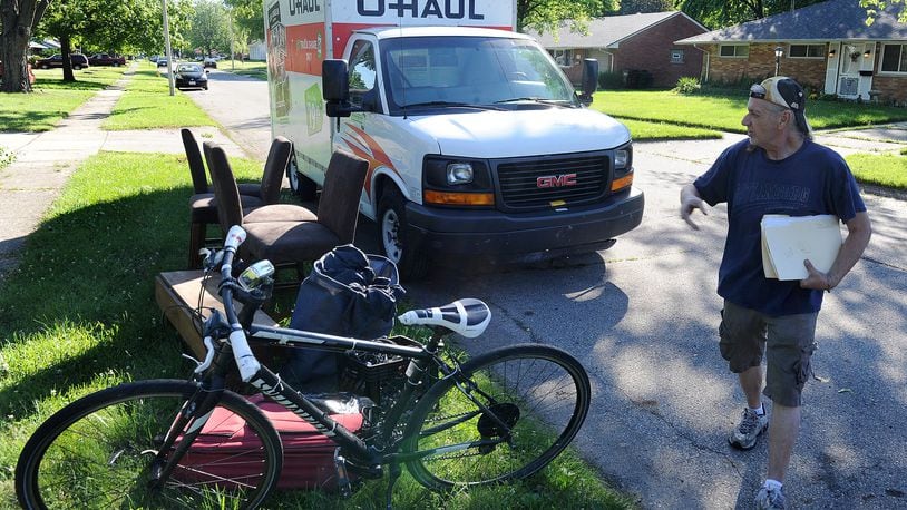 Daniel Sizemore moved his belongings to the curb after being evicted from his home in Kettering, Tuesday, June 15, 2021. MARSHALL GORBY\STAFF