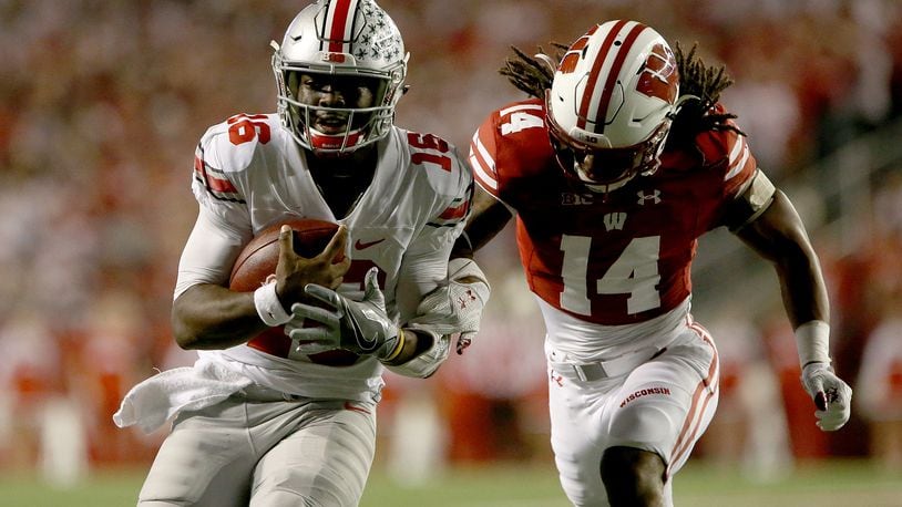 MADISON, WI - OCTOBER 15: D'Cota Dixon #14 of the Wisconsin Badgers chases after J.T. Barrett #16 of the Ohio State Buckeyes in the first quarter at Camp Randall Stadium on October 15, 2016 in Madison, Wisconsin. (Photo by Dylan Buell/Getty Images)