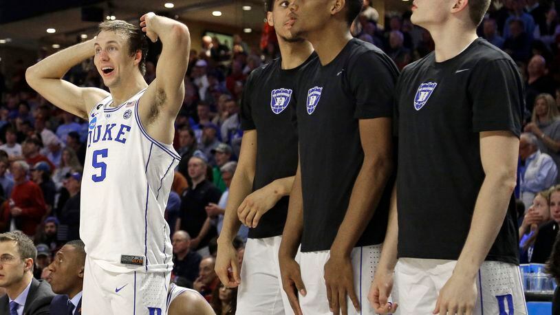 Duke players including Luke Kennard (5) watch the final minutes of the second half of a second-round game against South Carolina in the NCAA men’s college basketball tournament in Greenville, S.C., Sunday, March 19, 2017. South Carolina upset Duke 88-81. (AP Photo/Chuck Burton)