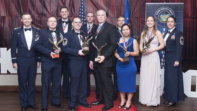 Col. Bradley McDonald (left), 88th Air Base Wing commander, and Chief Master Sgt. Paula Eischen (right), 88th Air Base Wing command chief, are pictured with the winners, in their respective categories, of the 2017 Team Wright-Patterson annual awards following a recognition banquet March 2 at Wright-Patterson Air Force Base. (U.S. Air Force photo/Wesley Farnsworth)
