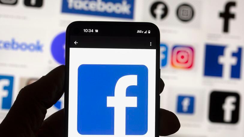 FILE - The Facebook logo is seen on a cell phone in Boston, USA, Oct. 14, 2022. The European Union said Tuesday April 30, 2024 that it's scrutinizing Facebook and Instagram over a range of suspected violations of the bloc's digital rulebook, including not doing enough to protect users from foreign disinformation ahead of EU-wide elections. (AP Photo/Michael Dwyer, File)