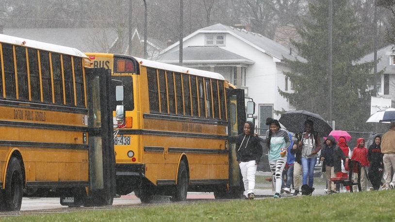 Students board buses Thursday at Edwin Joel Brown Middle School in Dayton. Dayton Public Schools bus drivers have filed a strike notice that would take effect April 10. CHRIS STEWART / STAFF