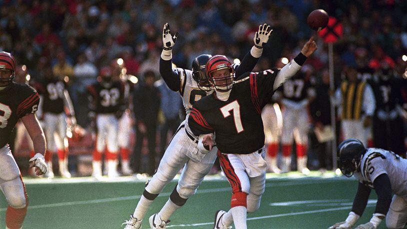 Cincinnati Bengals quarterback Boomer Esiason gets off a pass under pressure from San Diego Chargers defensive end Leslie ONeal during their NFL game at Riverfront Stadium in Cincinnati, Dec. 4, 1988. (AP Photo/Rob Burns)